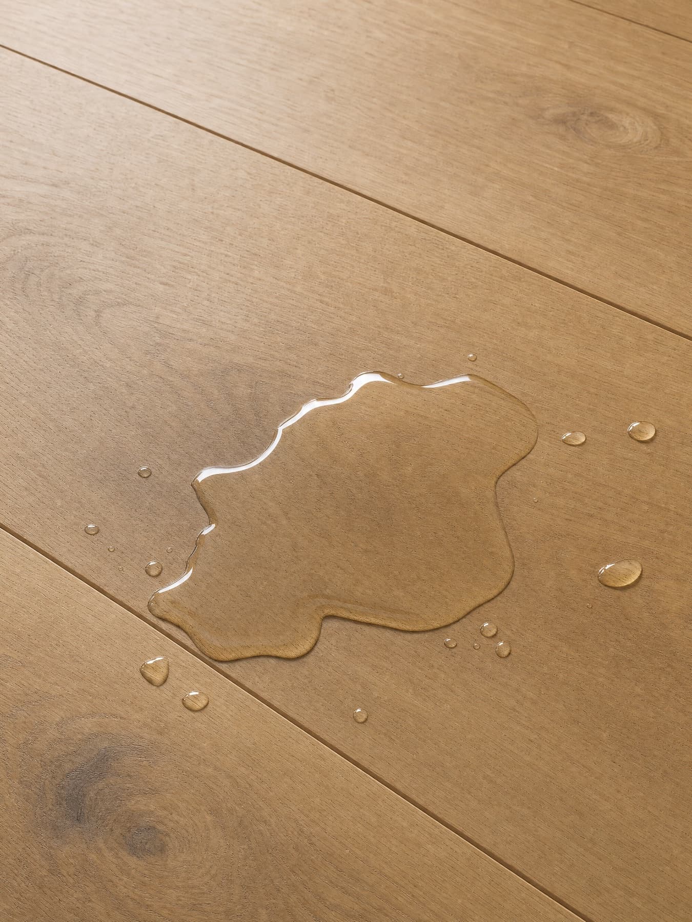A water droplet resting on Hansen Hardened Oak flooring
